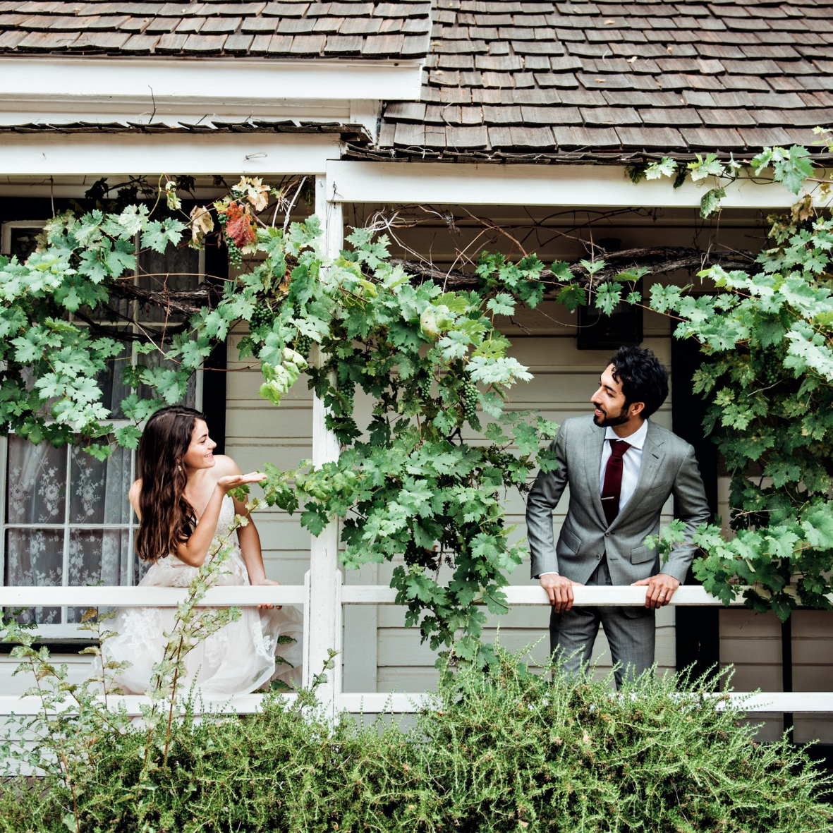 Couple looking at each other on balcony. 